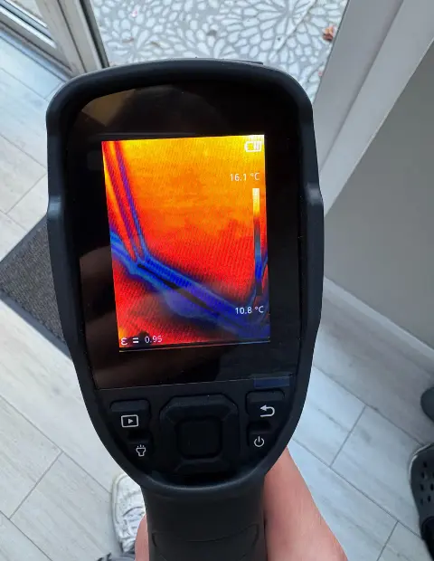 Thermal image showing cold air leaks around a window in a Dublin home, highlighting the need for draught repair and new seals