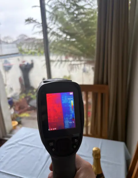 Infrared camera image showing improved insulation and reduced heat loss through newly upgraded double-glazed windows.